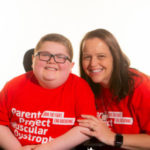 Seth and Tammy cate wearing a red Parent Project Muscular Dystrophy shirts