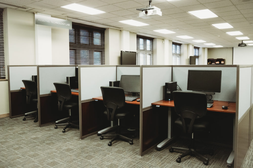 8 cubicals equipped with computers, adjustable desks, ergonomic chairs.