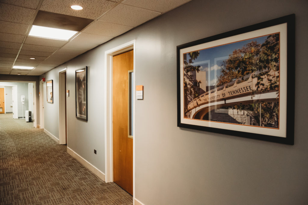Hallway from west entrance with UT pictures on the wall.