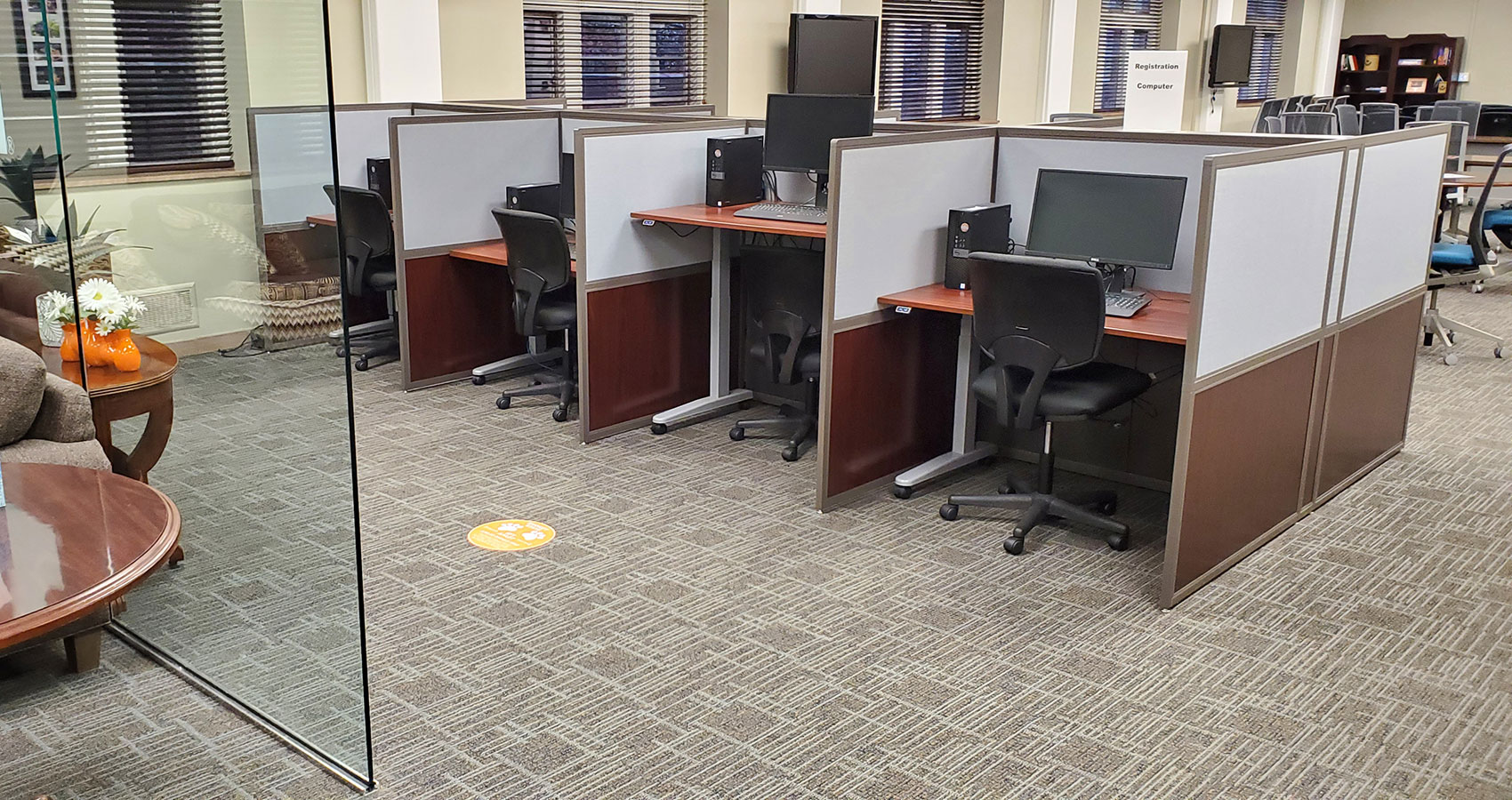 Four stations in the assistive technology lab equipped with computers and adjustable desks